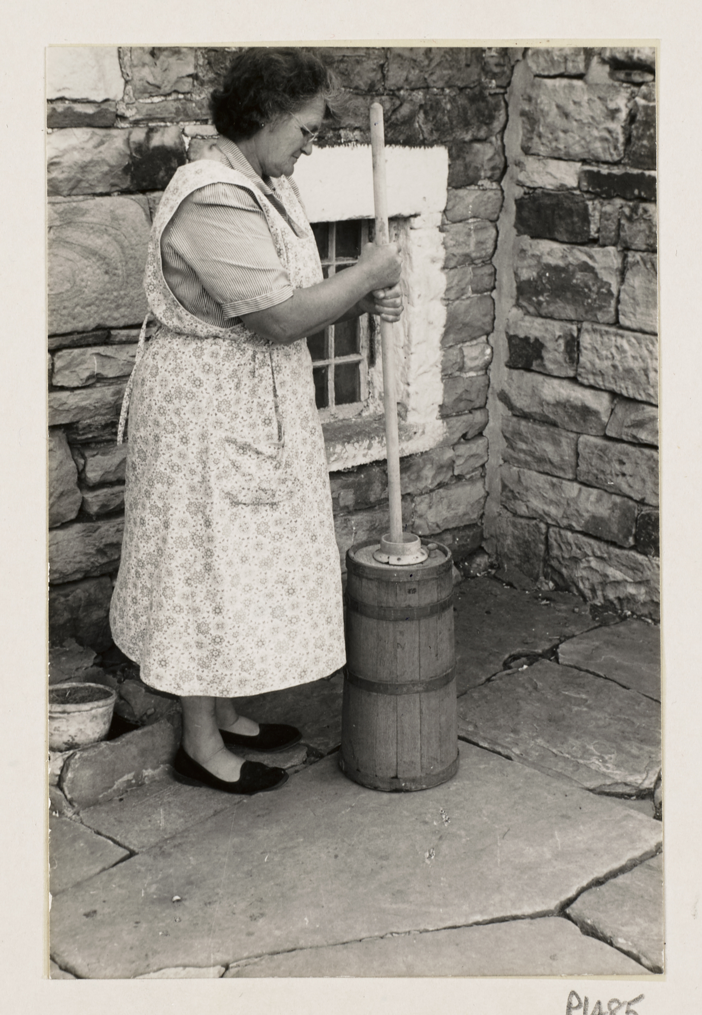 A person with wooden dairy tools