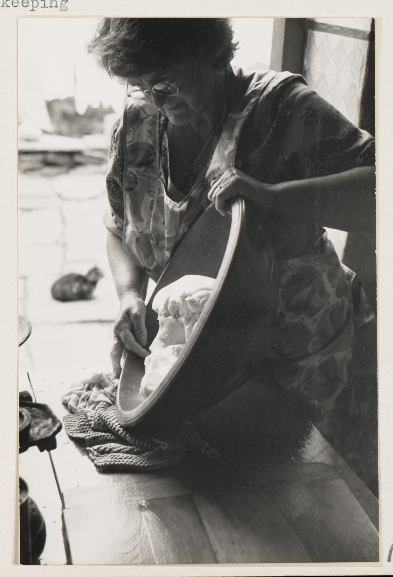 A person and a large bowl on a table
