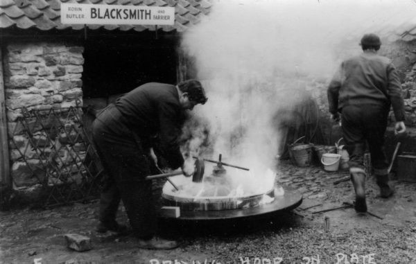 A person working at a forge