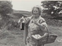 A person carrying a bottle and a basket