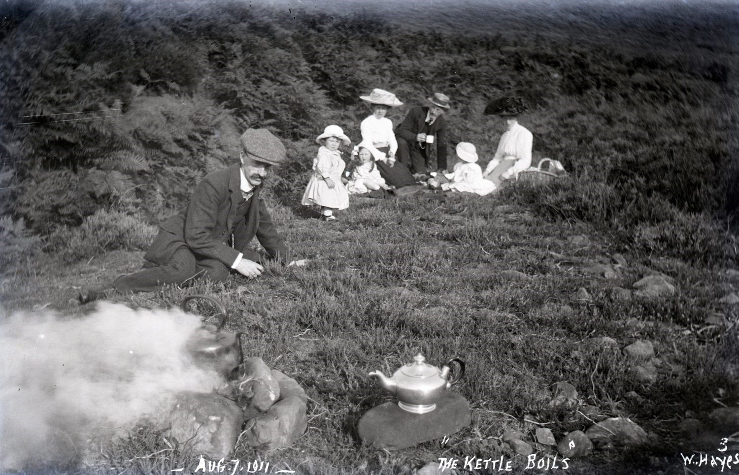 People and children sitting outside