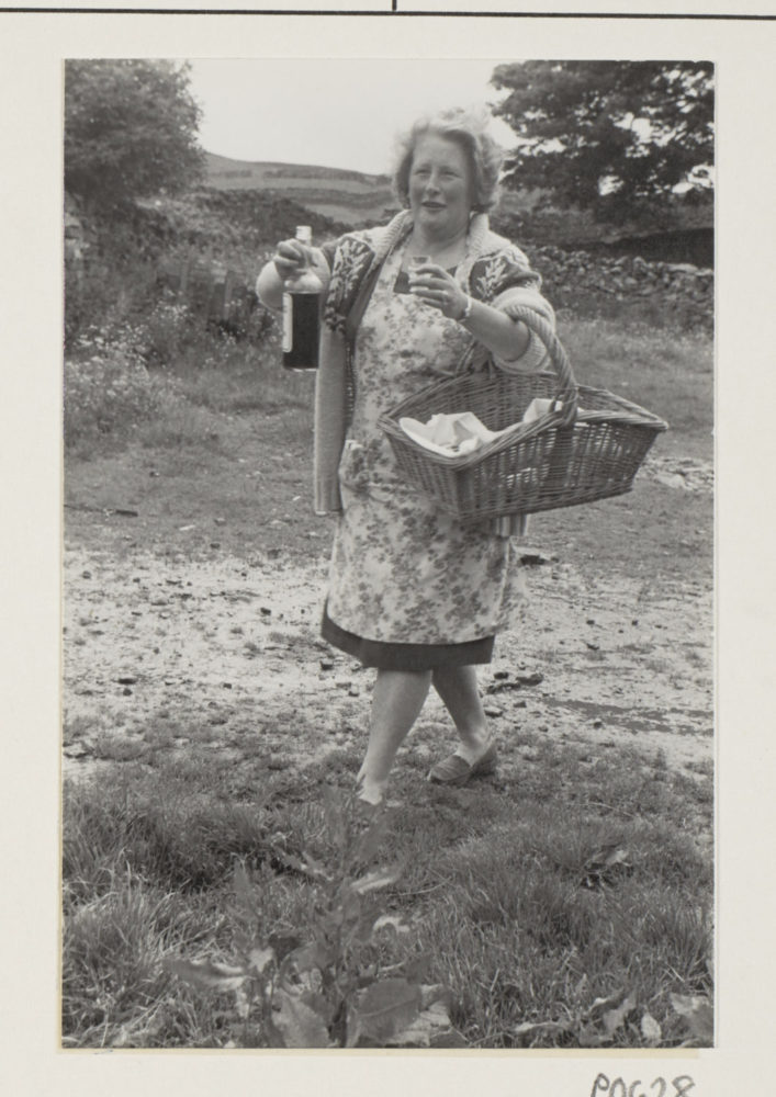 A person carrying a bottle and a basket