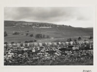 A hill with a dry stone wall in the foreground.