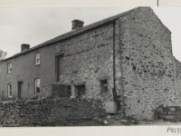 Dales farmstead with house and barn adjoining in one long building, at Marrick Moor ( Arkengarthdale). A wall divides the house and barns/cowshed.
