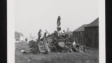 Children climbing on a pile of wood and discarded furniture which has been built up into a bonfire (unlit at this point), on wasteland in Dewsbury (West Yorkshire).