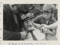 Mr. James Ward of West Witton ( Wensleydale) with a young boy, putting the finishing touches to the Bartle for the West Witton Bartle Fair.
